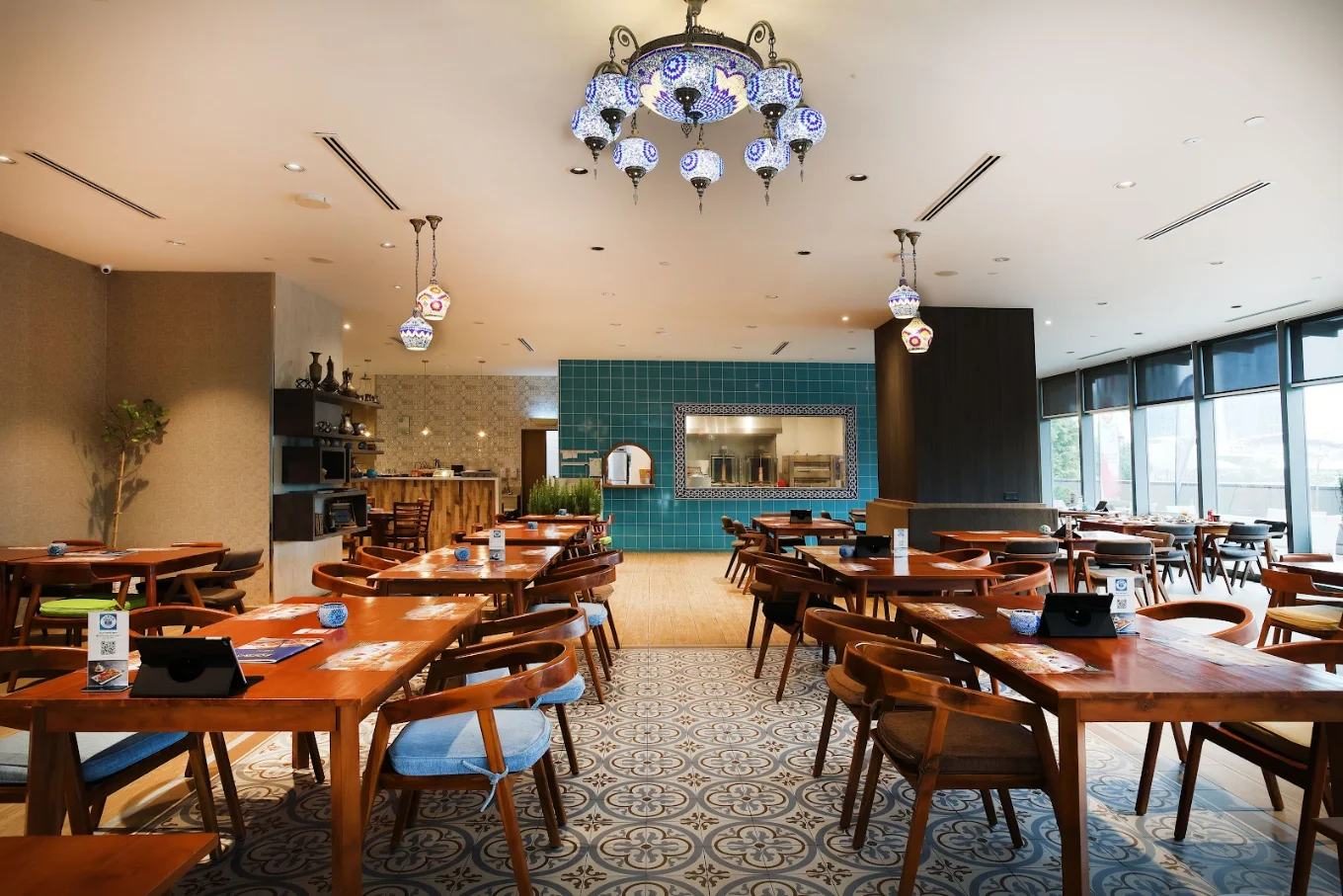 The Sofra dining room, warm and set for the evening