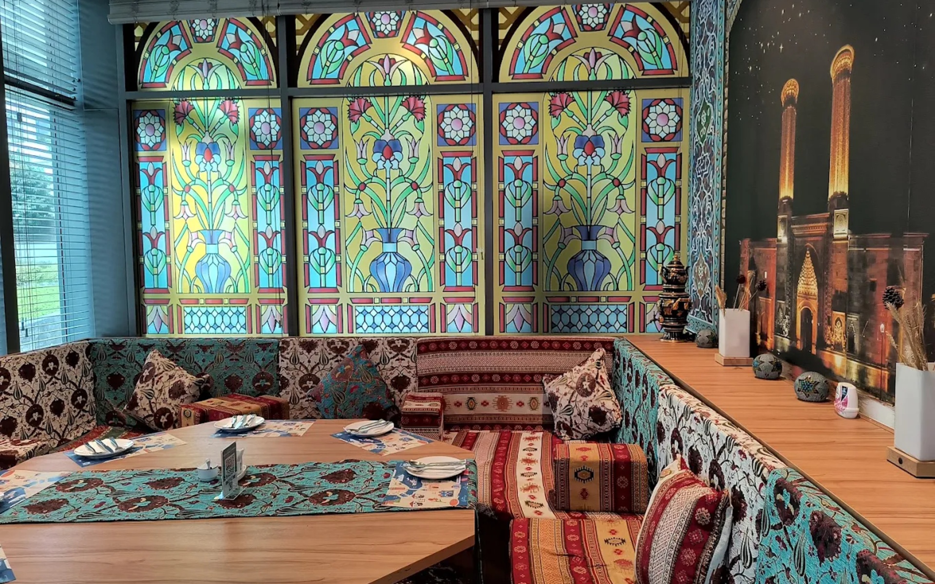 The low sofra corner, stained glass and kilim cushions